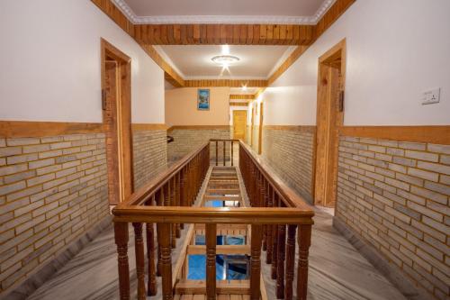 a walkway in a room with a brick wall at Trekkers Inn Boutique Hotel Pokhara in Pokhara