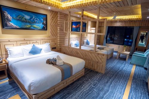 a bedroom with a bed and a tv and a couch at Trekkers Inn Boutique Hotel Pokhara in Pokhara