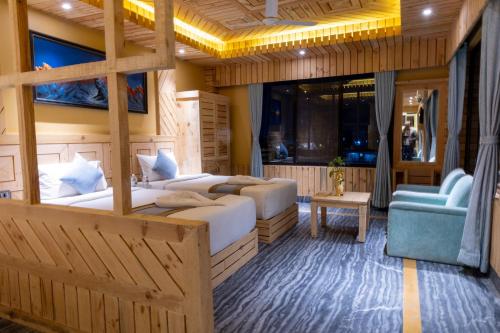 a bedroom with two beds and a blue couch at Trekkers Inn Boutique Hotel Pokhara in Pokhara