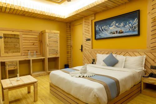 a bedroom with a large bed with yellow walls at Trekkers Inn Boutique Hotel Pokhara in Pokhara