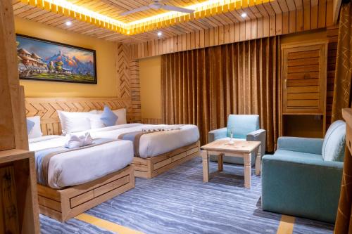a hotel room with two beds and a chair at Trekkers Inn Boutique Hotel Pokhara in Pokhara