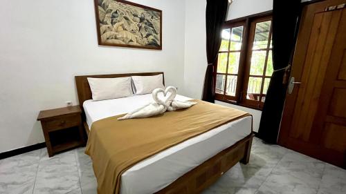 Postel nebo postele na pokoji v ubytování Adhya Guest House