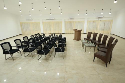 a row of chairs in a room with a podium at Aaditya Greens Near Nelaguli Panchyat Office in Kaglipur