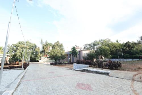 a cobblestone street in front of a building at Aaditya Greens Near Nelaguli Panchyat Office in Kaglipur
