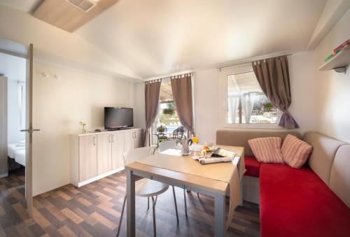 a small living room with a table and a couch at Aminess Planet Camping Holiday Homes Maravea in Novigrad Istria