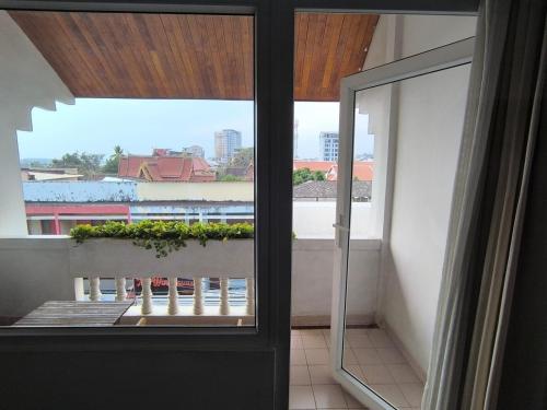 a view of a balcony from a room with a window at Le Charme Vientiane Hotel in Vientiane