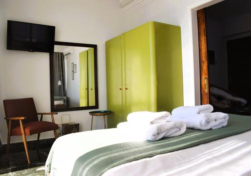 a bedroom with a bed with towels on it at Beach Side Apart II in Kavala