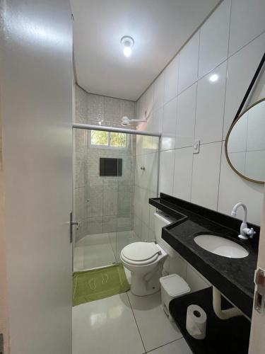 a bathroom with a shower and a toilet and a sink at Lotus Antunes Beach in Antunes