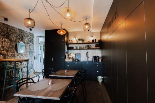 a dining room with two tables and a kitchen at Zimmerei in Murten