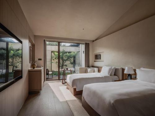Postel nebo postele na pokoji v ubytování 西安央辰酒店 Younch Hotel Xi'an