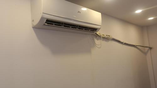 a air conditioner on the wall of a room at Amrah Resort in Bairāgarh