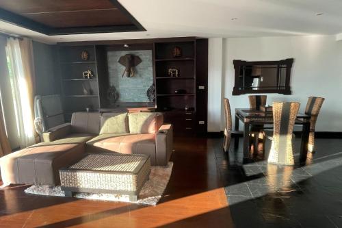 a living room with a couch and a table at Kamala Villa Hill in Kamala Beach
