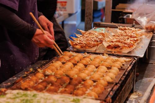 a person is preparing food on a buffet at Osaka - Hotel / Vacation STAY 70140 in Osaka