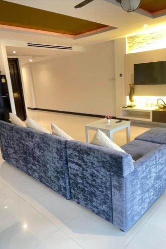 a living room with a couch in front of a screen at Kamala Villa Hill in Kamala Beach