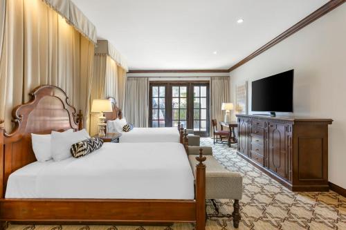 a bedroom with two beds and a flat screen tv at Omni Scottsdale Resort & Spa at Montelucia in Scottsdale