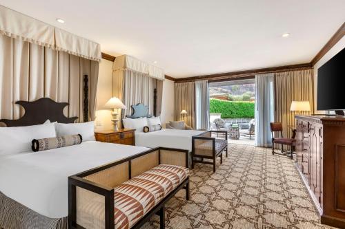 a hotel room with two beds and a balcony at Omni Scottsdale Resort & Spa at Montelucia in Scottsdale