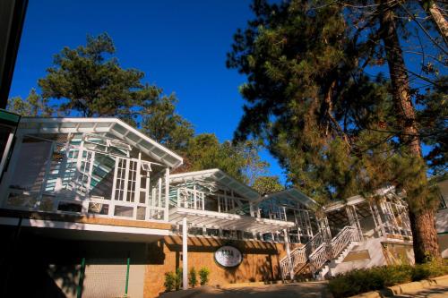 a large white building with a clock on it at The Brent Guest House in Baguio