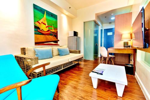 a living room with a couch and a table at Ferra Premier by JG in Boracay
