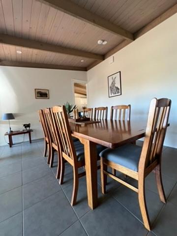 a dining room with a wooden table and chairs at Elevation652 at Mt Bellevue in King Valley in Myrrhee