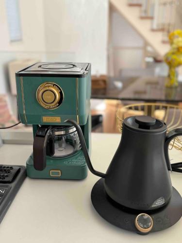 a green camera sitting on top of a table at Aqua Villa with Pool, Sauna, and 100 inch 4K Projector, 5-minute walk from Fujitsu Park Sea in Futtsu