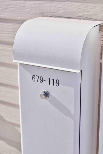 a white refrigerator freezer sitting on top of a wall at Aqua Villa with Pool, Sauna, and 100 inch 4K Projector, 5-minute walk from Fujitsu Park Sea in Futtsu