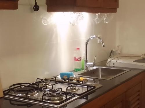 a kitchen with a stove and a sink at Villa28 Habaraduwa in Habaraduwa