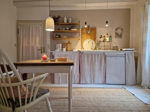 a kitchen with a table and a dining room at Kleine Auszeit in Detmold