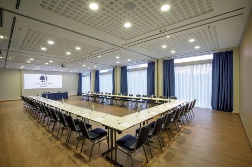 a large conference room with a long table and chairs at DoubleTree By Hilton Milan in Milan