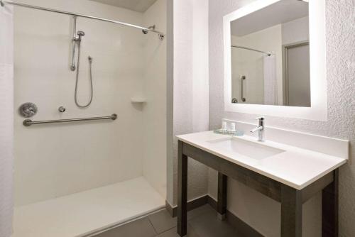a bathroom with a sink and a shower at La Quinta by Wyndham Atlanta Airport North in Atlanta
