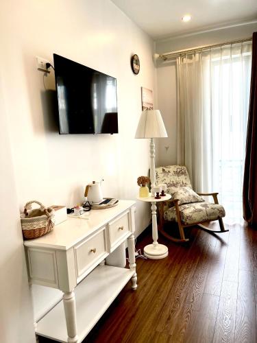 a white desk with a lamp and a chair in a room at C&K Premier Apartment Hai Phong in Hai Phong