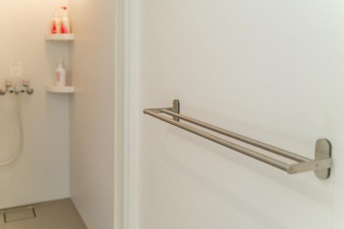a bathroom door with a towel rack on it at Flower Base Lily House - Vacation STAY 55522v in Fukuoka