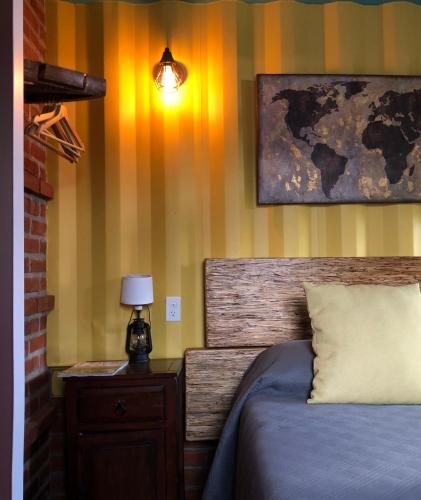 a bedroom with a bed and a lamp on a night stand at Chalet Contenedor con Hot Tub exterior exclusivo in Las Palmas
