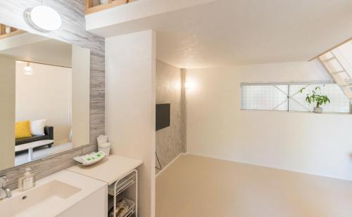 a bathroom with a sink and a mirror at Flower Base Lily House - Vacation STAY 57830v in Fukuoka