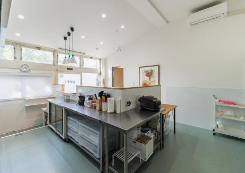 a large kitchen with a counter in a room at Flower Base Lily House - Vacation STAY 57830v in Fukuoka