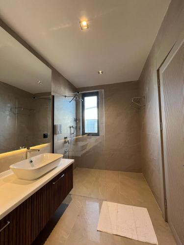 a large bathroom with a sink and a shower at Royal Garden 7 Villas in Dosemealti