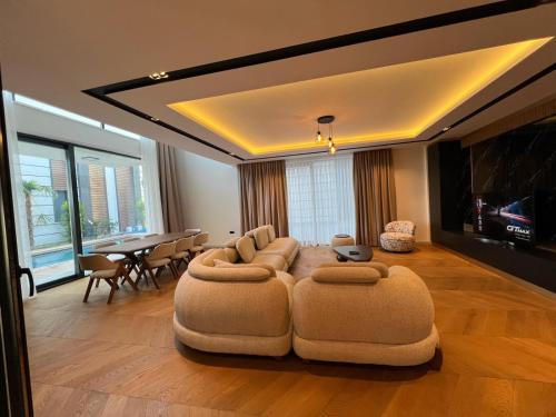 a large living room with a couch and a table at Royal Garden 7 Villas in Dosemealti