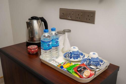 a tray with bottles of water on a table at Liora Homestay in Gelioya