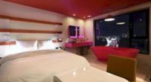 a bedroom with a bed and a chair and a tv at Circle Hotel Seoul in Seoul