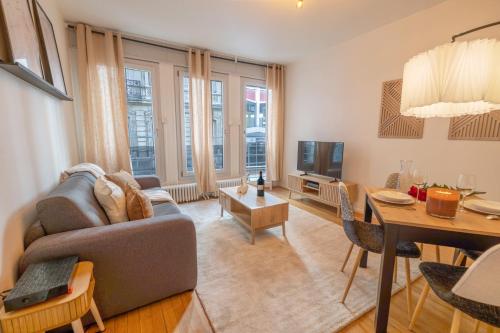 a living room with a couch and a table at Standing, confort, centre ville,4 personnes in Saint-Étienne