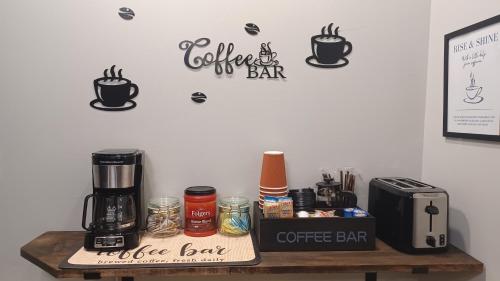 a coffee bar with a coffeemaker on a table at 1 Bedroom Piña Pecan House by Palace of Nobles in Charlotte