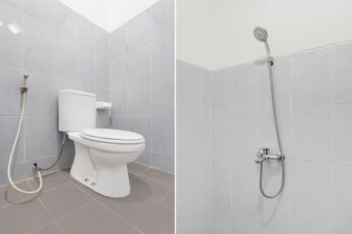 a bathroom with a toilet and a shower at Hotel O Kaliurang Near Gunung Merapi Kaliurang in Yogyakarta