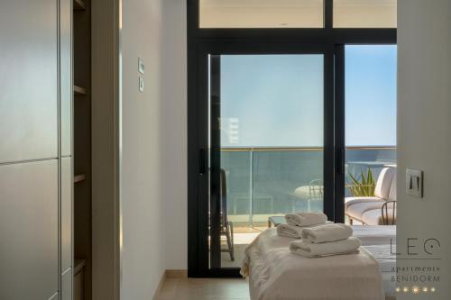 a room with a bed with folded towels on it at Sunset Cliffs Apartment by Leo Apartments Benidorm in Benidorm