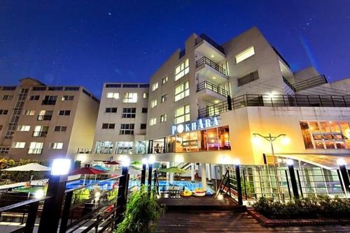 a large building with a pool in front of it at 거제 아쿠아리우스 in Geoje 