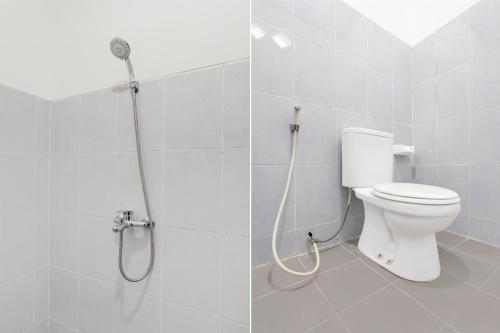 a bathroom with a shower with a toilet in it at Hotel O Kaliurang Near Gunung Merapi Kaliurang in Yogyakarta
