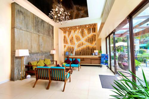 a lobby with chairs and a couch and a table at Ferra Premier by JG in Boracay