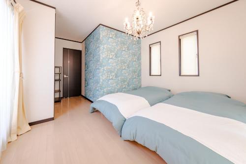 Postel nebo postele na pokoji v ubytování Hachioji Akatsuki Guest House 203