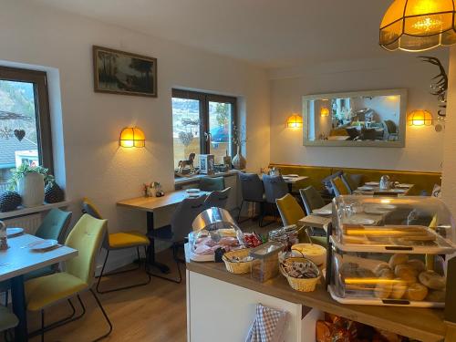 a restaurant with tables and chairs and a counter with food at Pension Jagerhof - Sommercard Inkl - 5 Min zum Hochzeiger in Jerzens