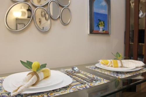 a table with two white plates and a mirror at Air Residences-Stylish&Comfort Stay High flat with balcony in Manila