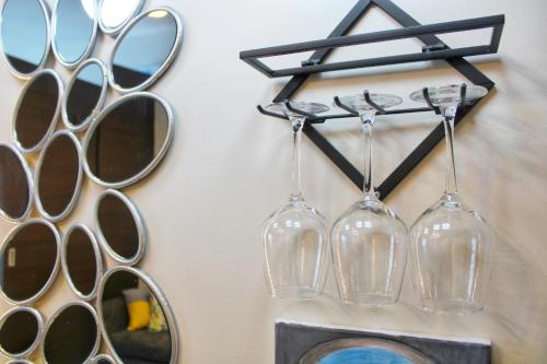 a group of wine glasses hanging on a wall at Air Residences-Stylish&Comfort Stay High flat with balcony in Manila