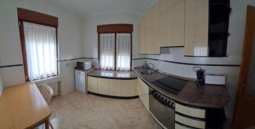 a kitchen with a sink and a counter top at Casa Javi in Ojedo